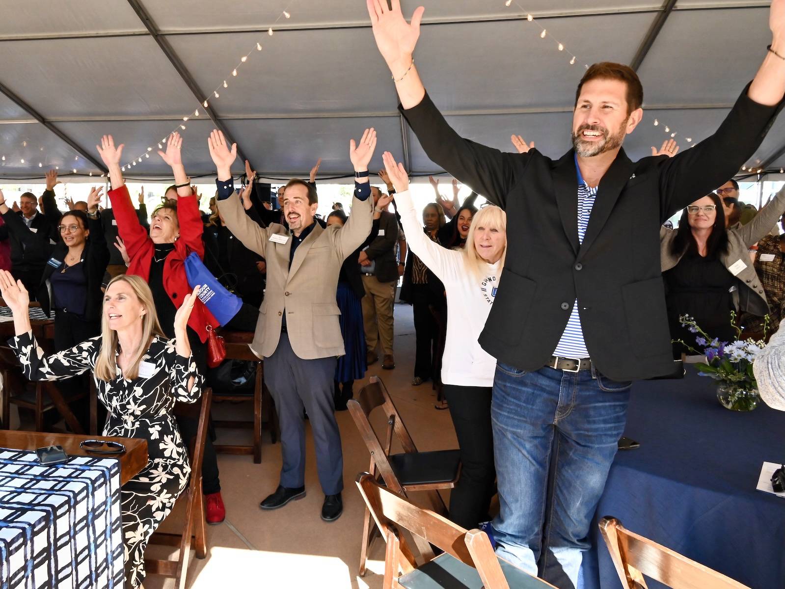 Grand Valley State University and Battle Creek leaders celebrate the playing of the university&#8217;s marching song